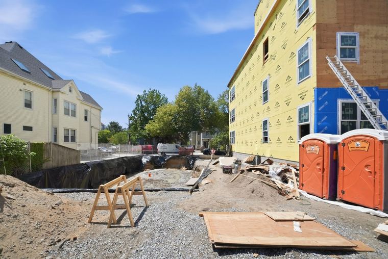 Excavation at the rear of the lot, the street building beyond