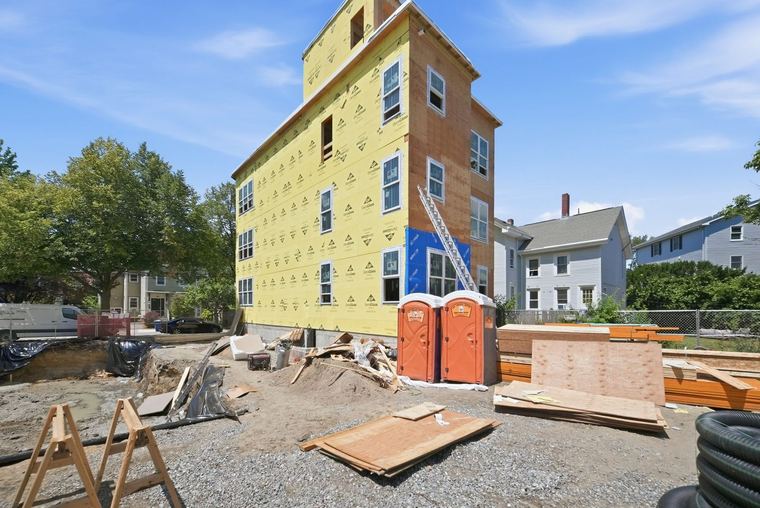 Sheathing and weather barrier going on